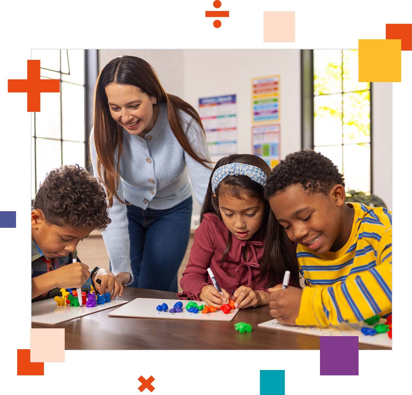 Three elementary students seated at a classroom table working with their teacher. Three elementary students seated at a classroom table working with their teacher.